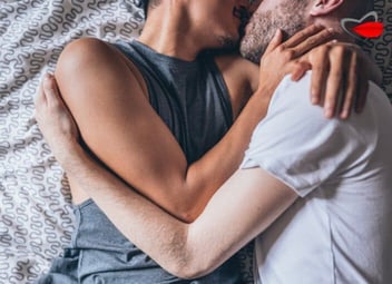 Screenshot of two men kissing and cuddling in bed with the Velvet Lips logo in the upper right corner of the image Screenshot of two men kissing and cuddling in bed with the Velvet Lips logo in the upper right corner of the image