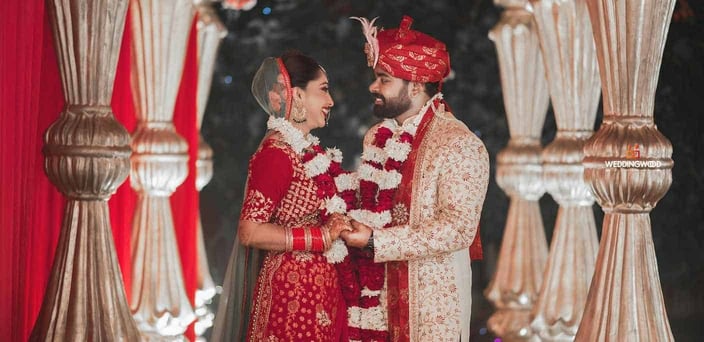 A photo of an Indian man and woman having a lavish wedding ceremony. A photo of an Indian man and woman having a lavish wedding ceremony.