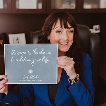 Photo of divorce coach Cat Blake holding a sign that says Divorce is the Chance to Redefine Your Life Photo of divorce coach Cat Blake holding a sign that says Divorce is the Chance to Redefine Your Life