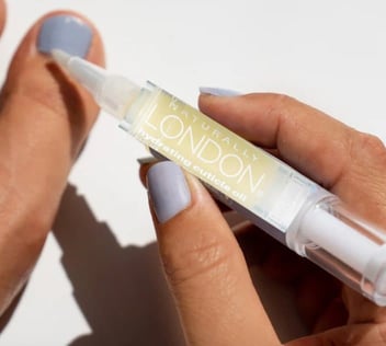 Screenshot of woman using Naturally London cuticle oil product Screenshot of woman using Naturally London cuticle oil product