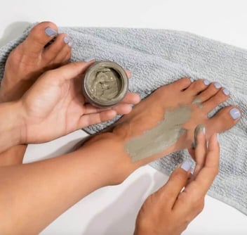 Close up of a woman's feet covered in Naturally London's exfoliating masque 