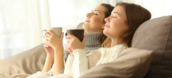 two women, relaxed, lying back with mugs two women, relaxed, lying back with mugs