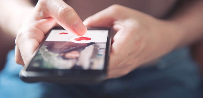 Person using dating app on phone
