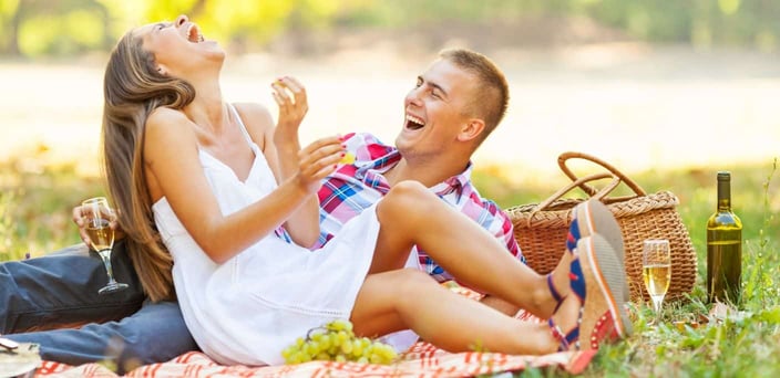 Couple laughing on a picnic
