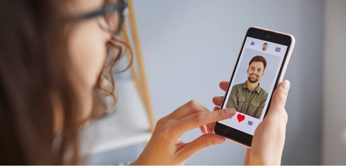 Woman swiping left on dating profile.