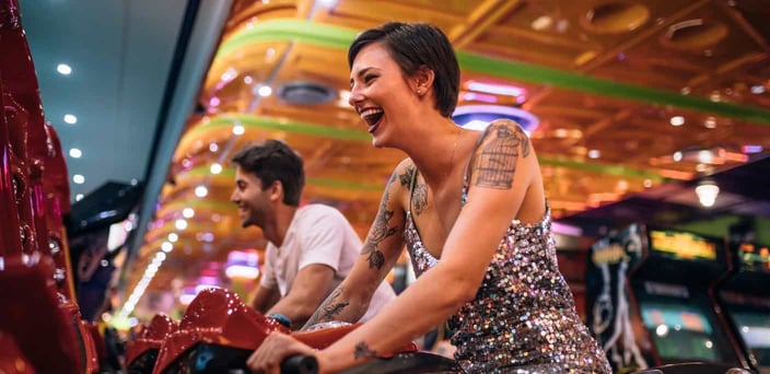 Couple playing racing game at arcade
