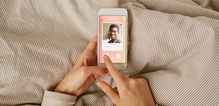 Photo of woman swiping dating profiles
