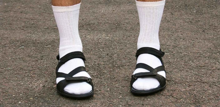 Photo of man wearing white socks with black sandals