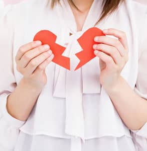 Photo of someone holding a ripped heart Photo of someone holding a ripped heart