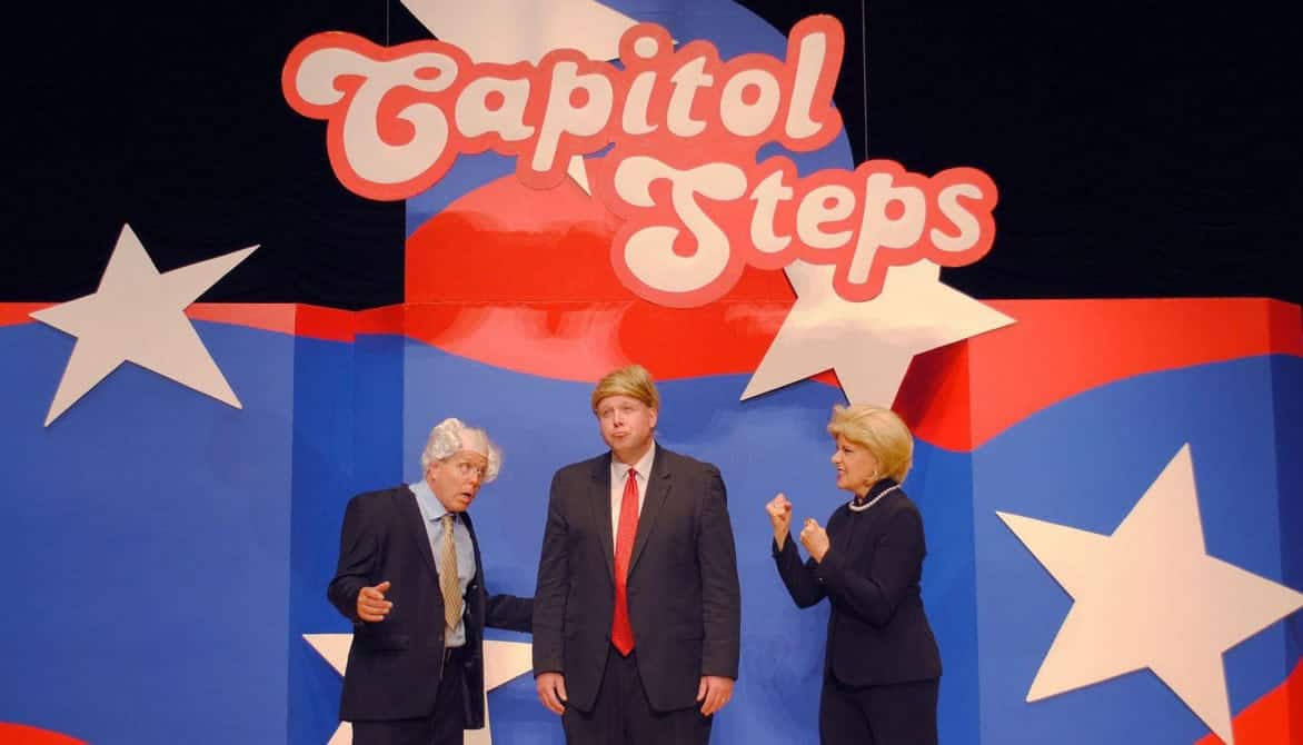 Photo of Capitol Steps members onstage during a performance Photo of Capitol Steps members onstage during a performance