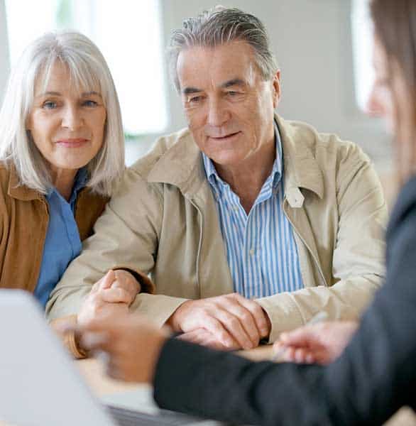 Photo of a couple with a financial adviser Photo of a couple with a financial adviser