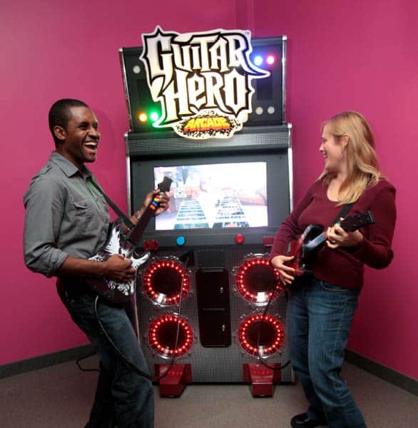 Photo of a couple playing Guitar Hero Photo of a couple playing Guitar Hero